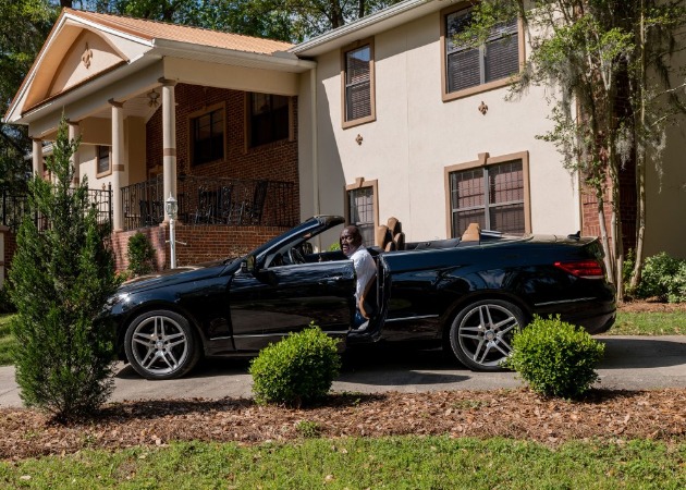 Genae Angelique Crump's husband Benjamin Entring on the car in front of his house.